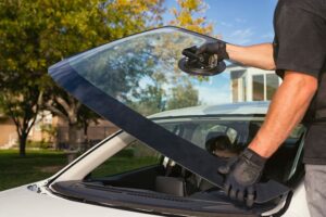 A man replace windshield glass in the car in Homestead, FL