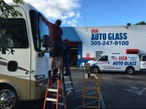 The USA auto glass staff replacing windshield of truck at miami, Florida